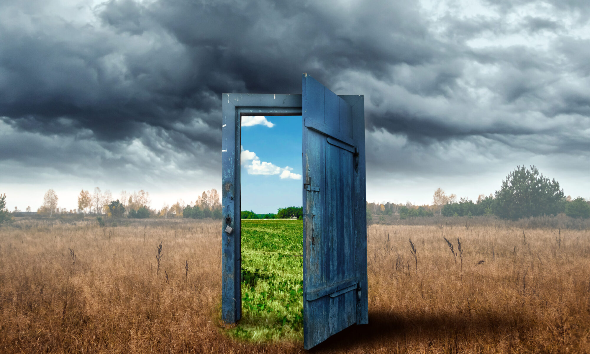 Creative background. Old wooden door, blue color, in the box. Transition to a different climate. The concept of climate change, portal, magic. Copy space.